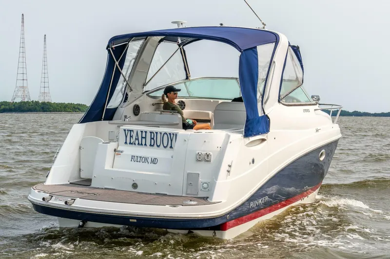 Slide: The Image of 2018 Rinker EX 270 boat named "Yeah Buoy" cruising on open water. - 5