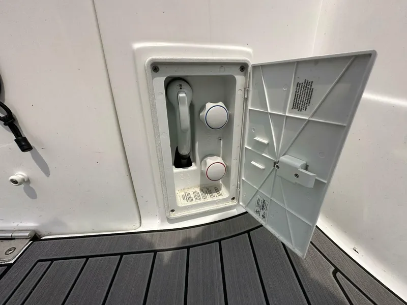 Slide: The Image of 2018 Rinker EX 270 boat shower compartment with open cover on deck. - 7