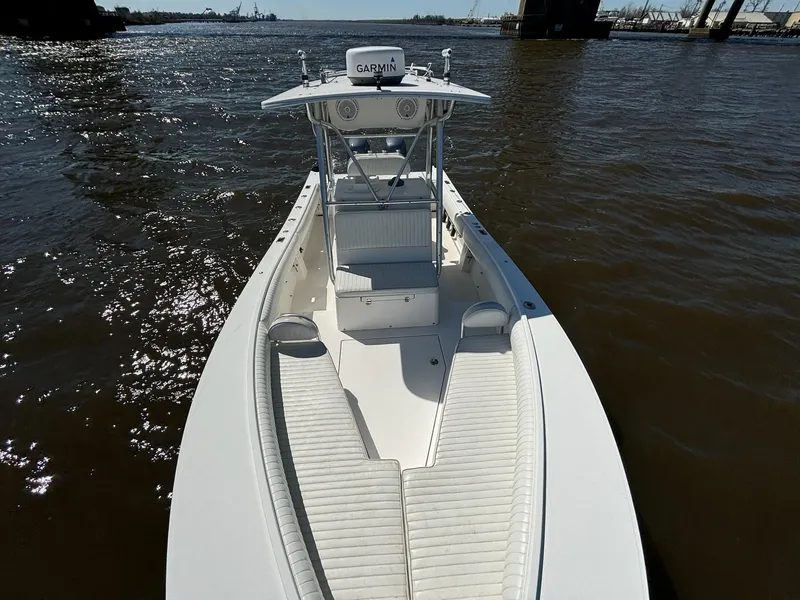 Slide: The Image of 2005 Regulator 24 FS boat on water, featuring spacious deck and Garmin equipment. - 5