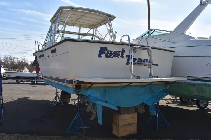 Slide: The Image of 1984 Tiara Sport 2700 boat on stands, rear view, with "Fast" lettering. - 12