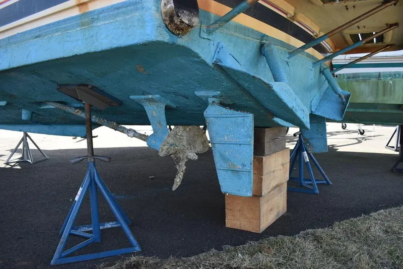 Slide: The Image of 1984 Tiara Sport 2700 boat on stands, showing hull and propeller detail. - 14