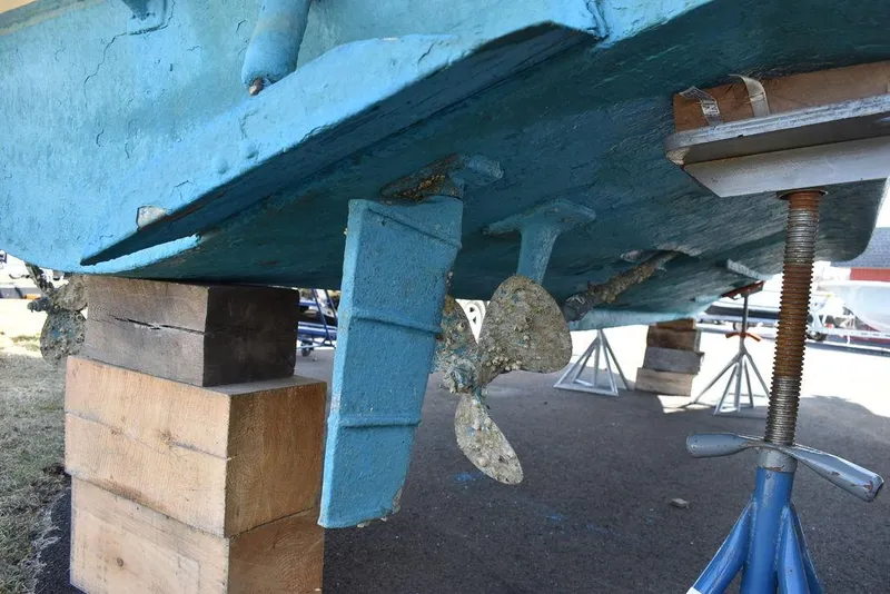Slide: The Image of 1984 Tiara Sport 2700 boat hull and propeller on blocks for maintenance. - 15