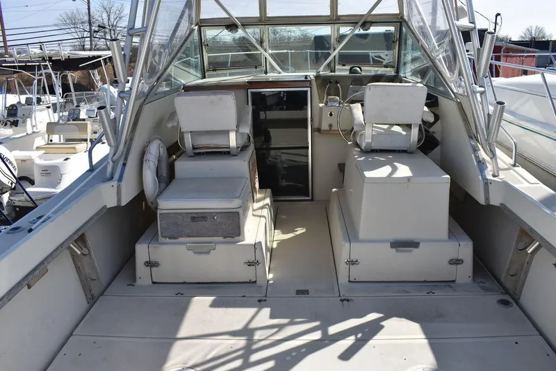Slide: The Image of 1984 Tiara Sport 2700 boat interior with dual seats and steering console. - 17