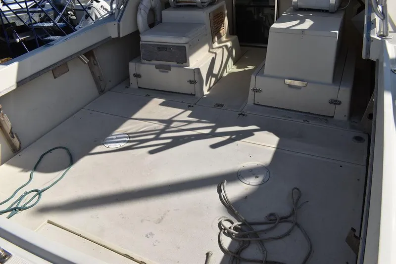 Slide: The Image of 1984 Tiara Sport 2700 boat deck with storage compartments and ropes. - 18