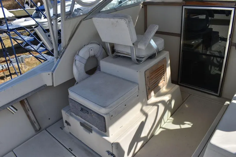 Slide: The Image of 1984 Tiara Sport 2700 boat interior with seating and life preserver. - 21