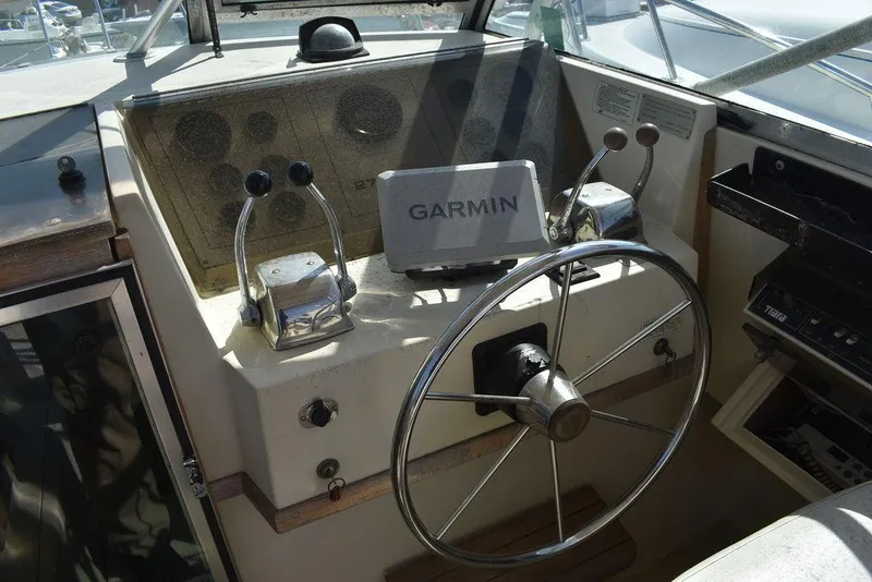Slide: The Image of Cockpit of 1984 Tiara Sport 2700 with Garmin navigation system and dual throttle controls. - 22