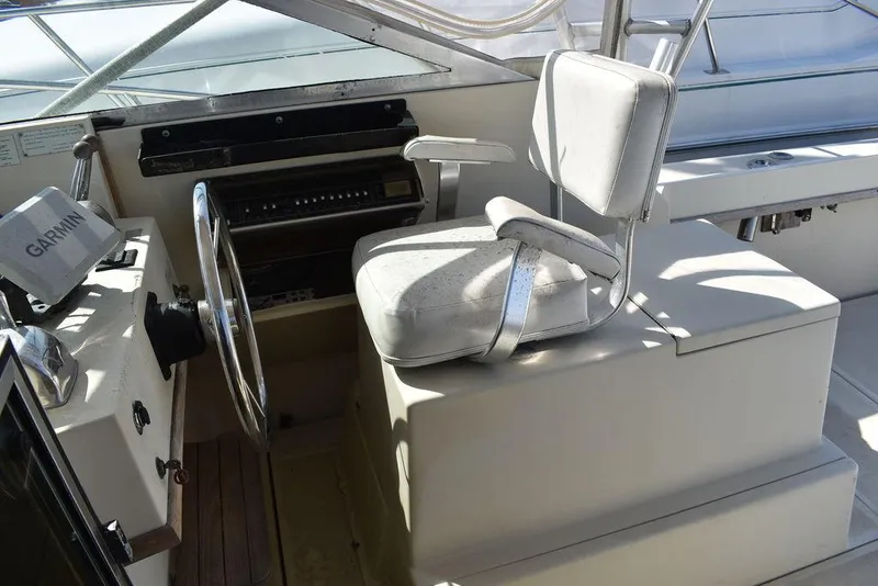 Slide: The Image of 1984 Tiara Sport 2700 boat helm with steering wheel and captain's chair. - 24