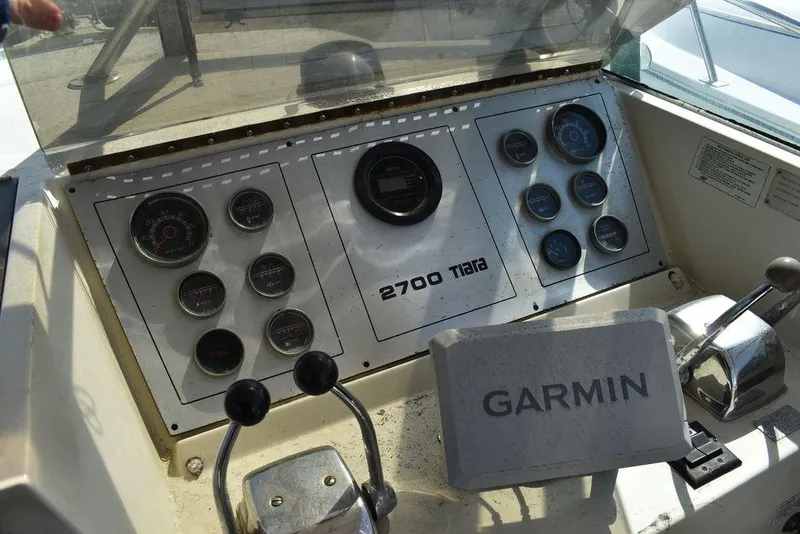 Slide: The Image of Dashboard of a 1984 Tiara Sport 2700 boat with Garmin navigation system. - 26