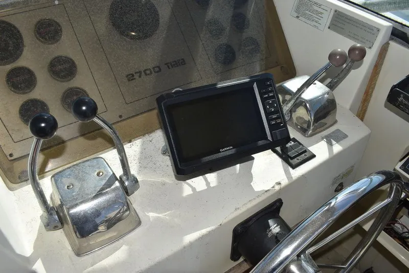 Slide: The Image of Control panel of a 1984 Tiara Sport 2700 boat with navigation equipment. - 27