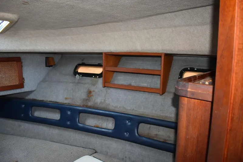 Slide: The Image of Interior cabin of 1984 Tiara Sport 2700 boat with wooden shelves and portholes. - 32