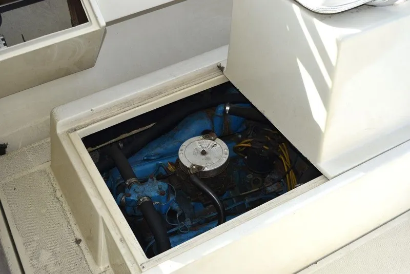 Slide: The Image of Engine compartment of a 1984 Tiara Sport 2700 boat, showcasing internal components. - 39
