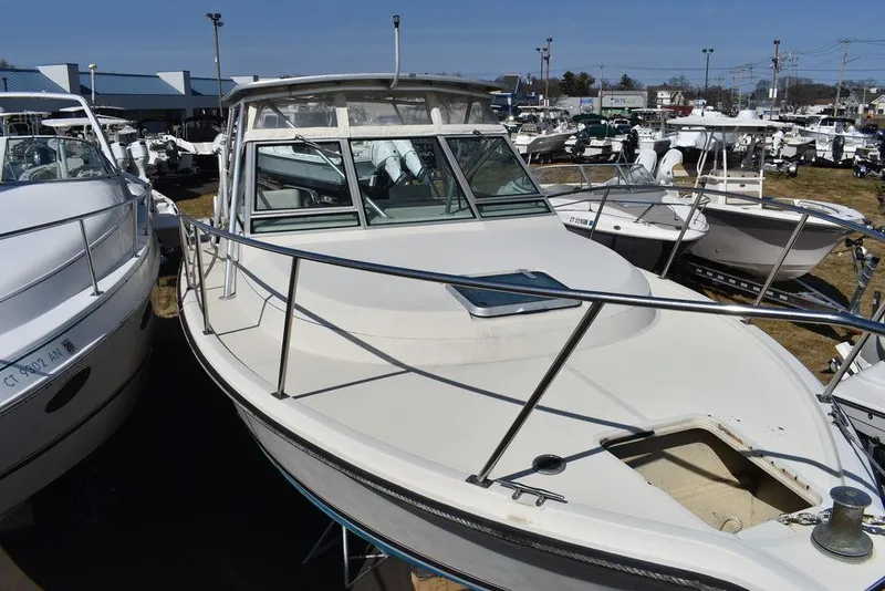 Slide: The Image of 1984 Tiara Sport 2700 boat displayed in a marina, surrounded by other vessels. - 4