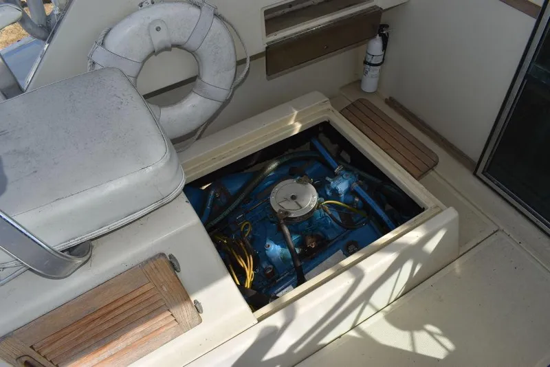 Slide: The Image of 1984 Tiara Sport 2700 boat engine compartment with visible life preserver and fire extinguisher. - 40