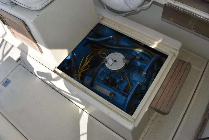 Slide: The Image of Engine compartment of a 1984 Tiara Sport 2700 boat, showcasing blue engine and wiring. - 41