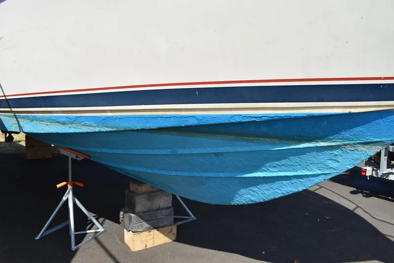 Slide: The Image of 1984 Tiara Sport 2700 boat hull on stands, blue and white paint. - 7