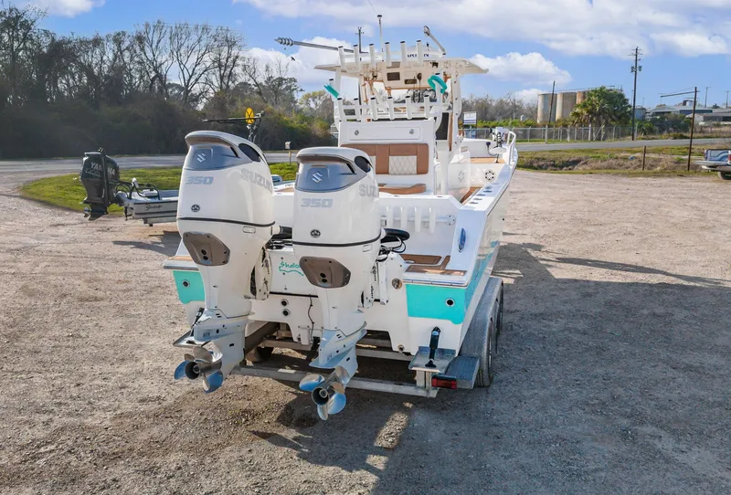 Slide: The Image of 2019 Shallow Sport 32 X3 boat with dual Suzuki engines on a trailer. - 10