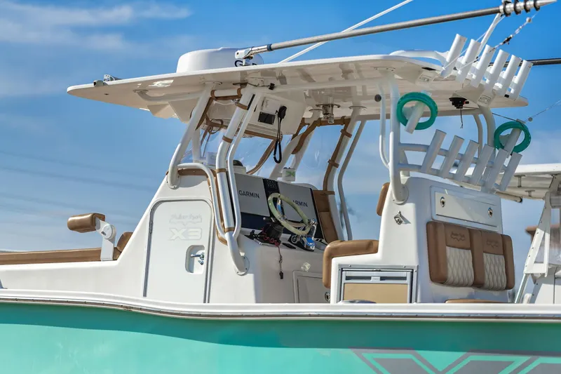 Slide: The Image of 2019 Shallow Sport 32 X3 boat with modern helm and fishing rod holders. - 14
