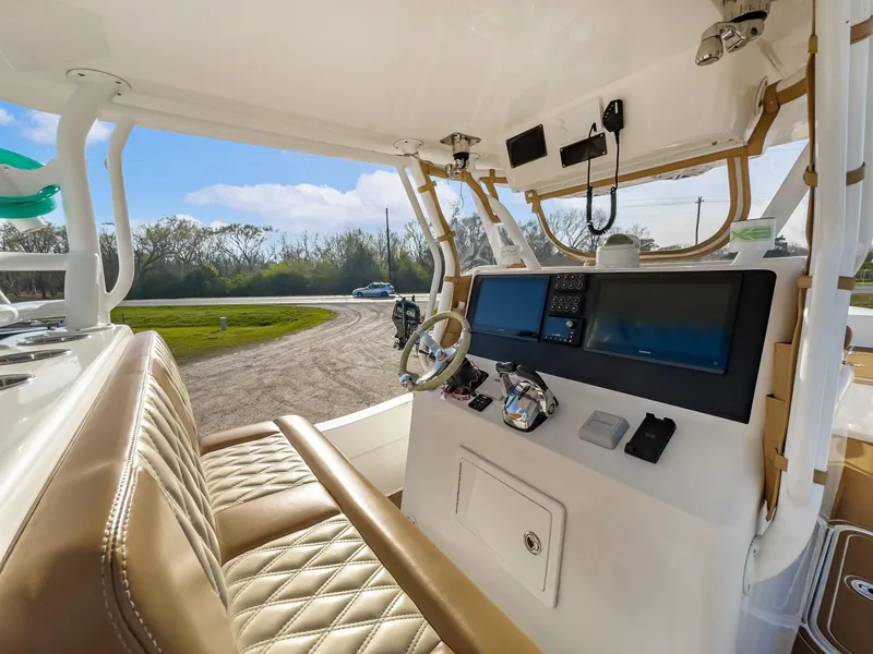 Slide: The Image of 2019 Shallow Sport 32 X3 boat interior with modern dashboard and leather seating. - 19