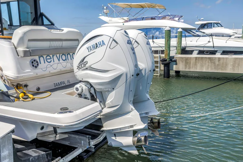 Slide: The Image of 2022 Regal 36 XO boat with Yamaha outboard engines docked in marina. - 11