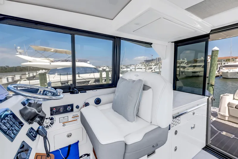 Slide: The Image of Interior of 2022 Regal 36 XO yacht with helm and marina view. - 16