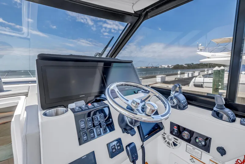 Slide: The Image of Helm of 2022 Regal 36 XO boat with modern controls and navigation equipment. - 17