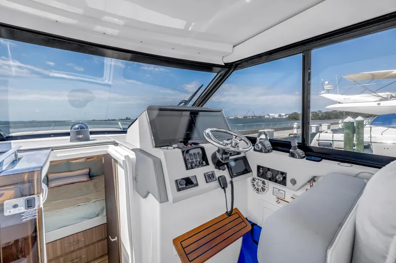 Slide: The Image of Interior view of 2022 Regal 36 XO yacht cockpit with modern controls and ocean view. - 20