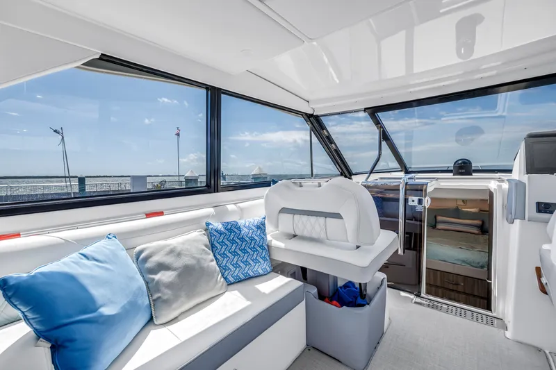 Slide: The Image of Interior of 2022 Regal 36 XO yacht with plush seating and scenic ocean view. - 23