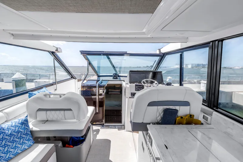 Slide: The Image of Interior view of 2022 Regal 36 XO yacht, featuring modern helm and seating area. - 27