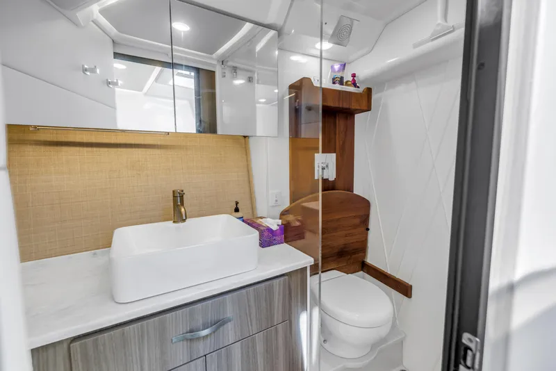 Slide: The Image of Modern bathroom in 2022 Regal 36 XO yacht with sleek fixtures and wood accents. - 33