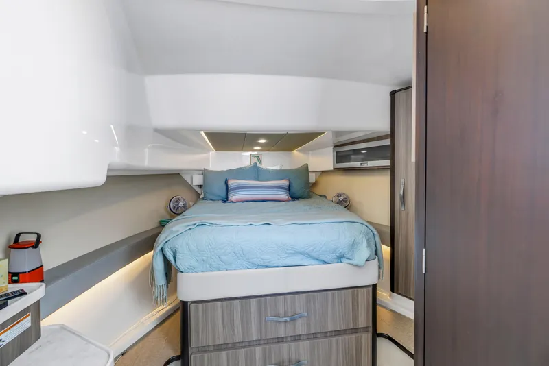 Slide: The Image of 2022 Regal 36 XO cabin interior with bed, modern design, and storage drawers. - 35