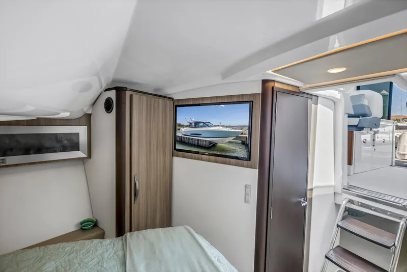 Slide: The Image of Interior cabin of 2022 Regal 36 XO yacht with modern design and cozy bed. - 37