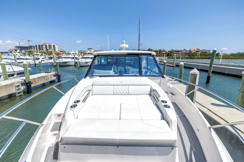 Slide: The Image of 2022 Regal 36 XO yacht docked at marina under clear blue sky. - 7