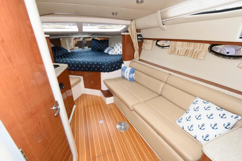 Slide: The Image of Interior of 2007 Regal 3360 Window Express yacht with cozy seating and sleeping area. - 10