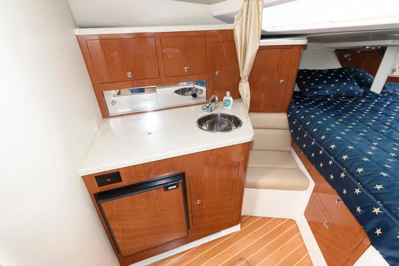 Slide: The Image of 2007 Regal 3360 Window Express cabin with kitchenette and bed. - 12