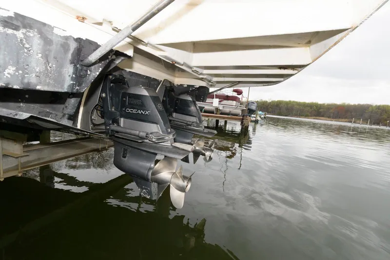 Slide: The Image of 2007 Regal 3360 Window Express boat with dual outboard motors in water. - 21