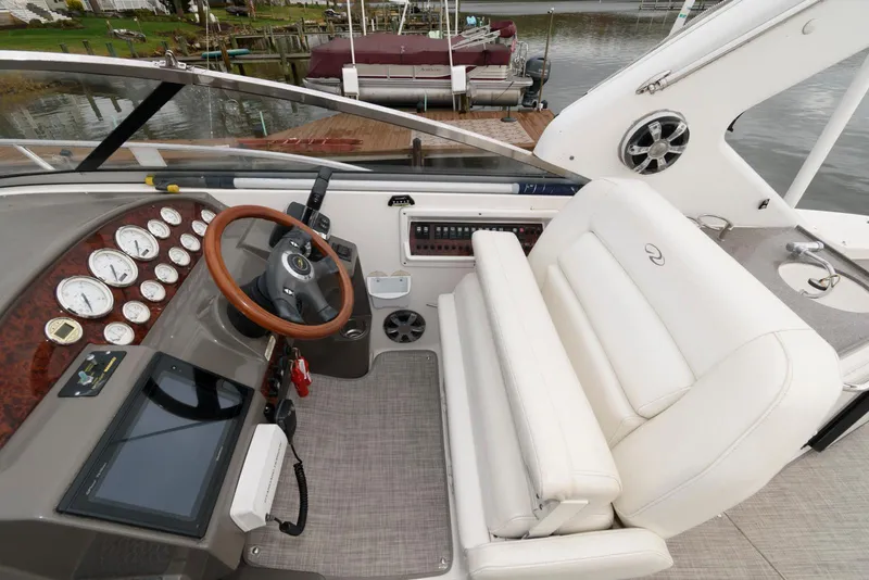 Slide: The Image of 2007 Regal 3360 Window Express boat cockpit with steering wheel and control panel. - 7