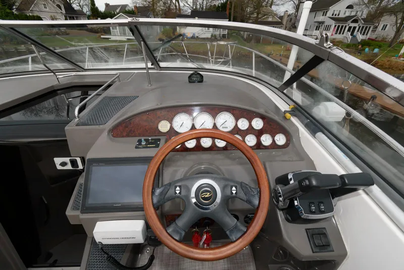 Slide: The Image of 2007 Regal 3360 Window Express boat dashboard with steering wheel and control panel. - 8