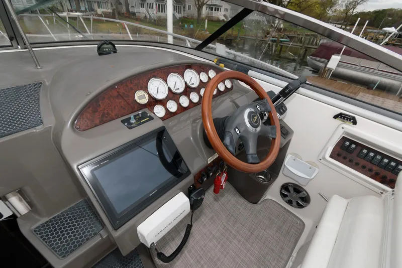 Slide: The Image of 2007 Regal 3360 Window Express boat dashboard with wood accents and modern controls. - 9