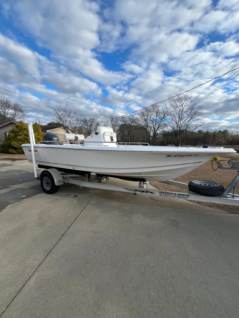 The Image of 2013 Tidewater 1910 Baymax boat on trailer under cloudy sky. - 1