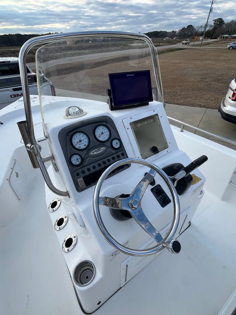 Slide: The Image of 2013 Tidewater 1910 Baymax boat console with steering wheel, gauges, and navigation equipment. - 6