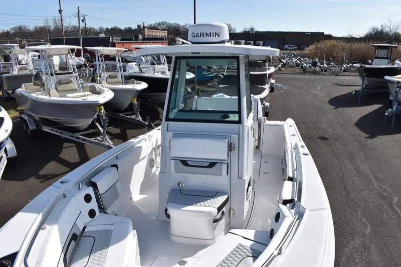 Slide: The Image of 2025 Blackfin 252CC boat with Garmin equipment, displayed in a marina setting. - 19