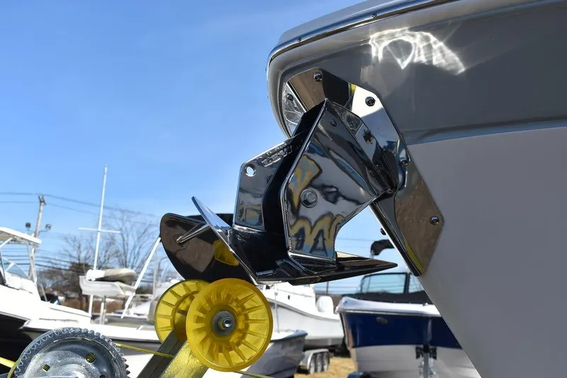 Slide: The Image of 2025 Blackfin 252CC boat anchor detail with chrome finish and yellow roller. - 21