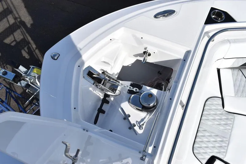 Slide: The Image of 2025 Blackfin 252CC boat anchor compartment with winch and storage. - 22