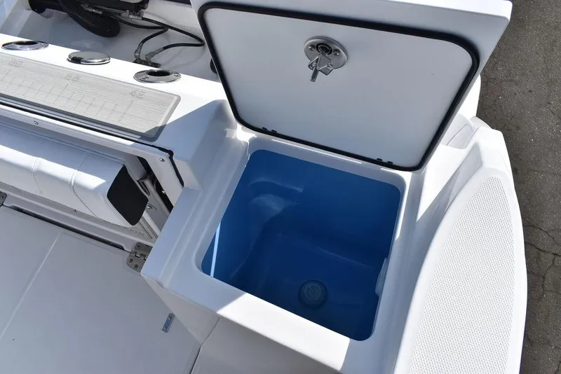 Slide: The Image of 2025 Blackfin 252CC boat with open storage compartment and blue interior. - 28