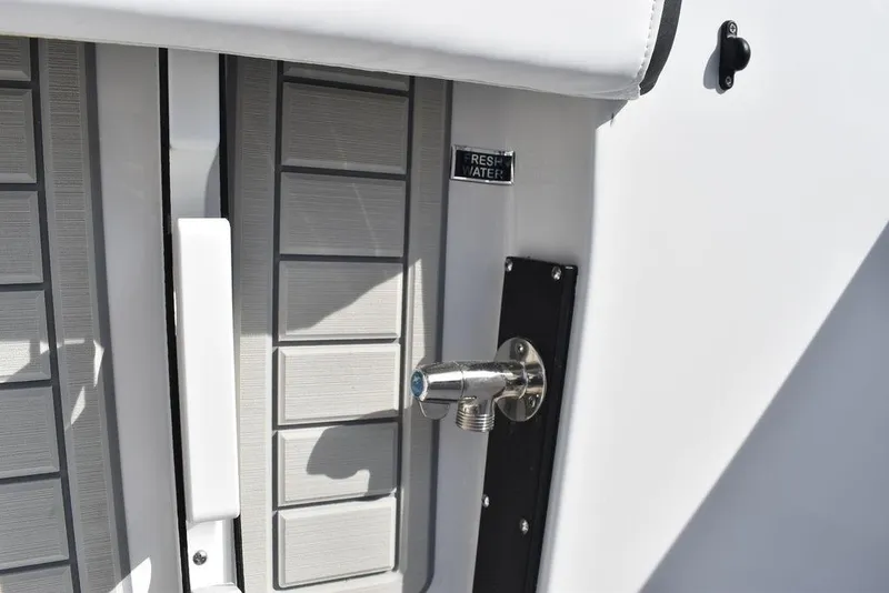 Slide: The Image of 2025 Blackfin 252CC boat detail showing fresh water outlet and deck design. - 30