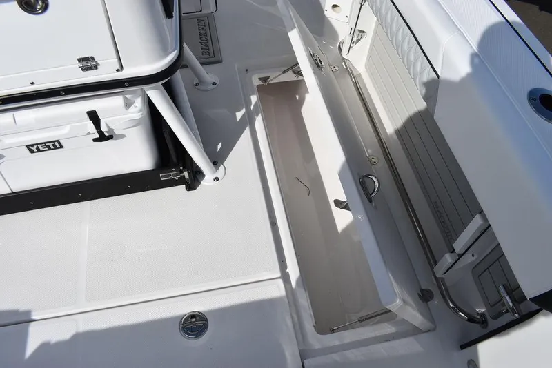 Slide: The Image of 2025 Blackfin 252CC boat deck with storage compartment and Yeti cooler. - 34