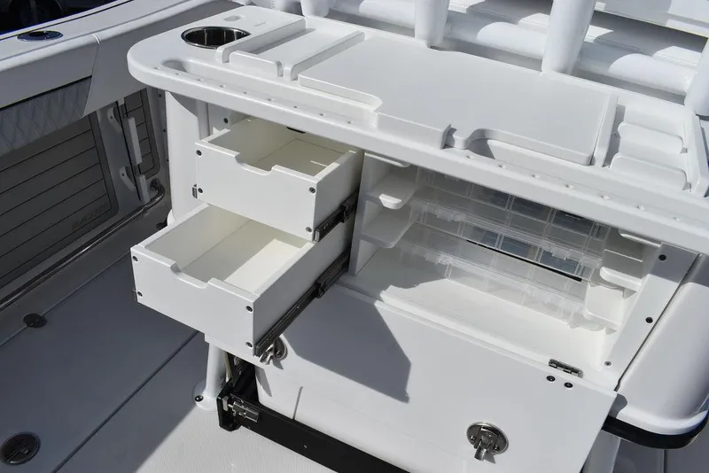 Slide: The Image of 2025 Blackfin 252CC boat storage compartments with open drawers and tackle storage. - 37