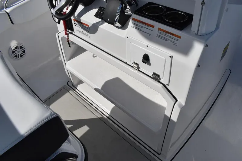 Slide: The Image of 2025 Blackfin 252CC boat console with steering wheel and storage compartment. - 42