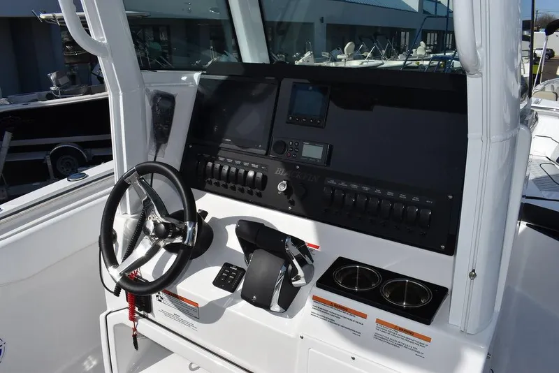 Slide: The Image of 2025 Blackfin 252CC boat dashboard with steering wheel and control panel. - 44