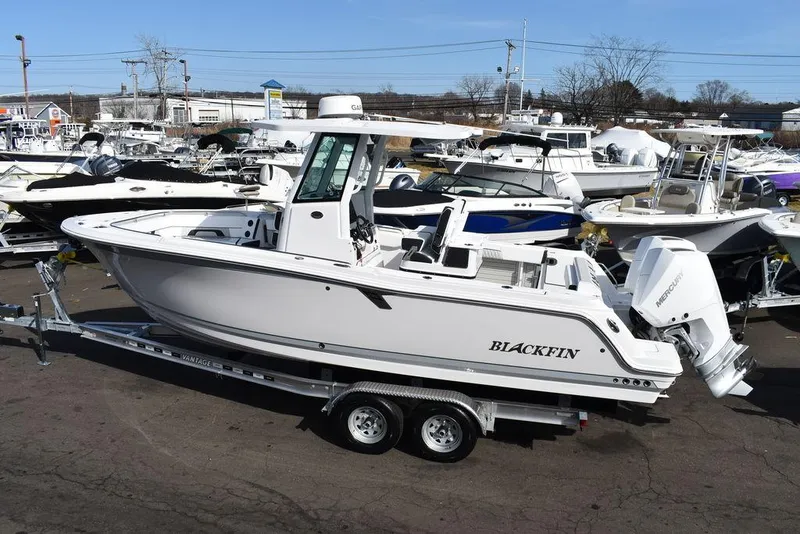 Slide: The Image of 2025 Blackfin 252CC boat on trailer in marina setting. - 5